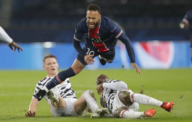 PSG's Neymar is challenged by Manchester United's Aaron Wan-Bissaka, right, and Scott McTominay during the Champions League group H soccer match between Paris Saint-Germain and Manchester United at the Parc des Princes in Paris, France, Tuesday, October 20, 2020. (Photo by Michel Euler/AP Photo)