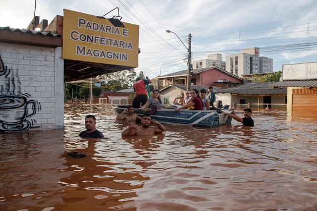 A rescue team evacuate flood-affected people in Santo Afonso, Novo Hamburgo, in the state of Rio Grande do Sul, Brazil, on May 7, 2024. Five more people were killed by storms ravaging south Brazil's Rio Grande do Sul state in the last 24 hours, bringing the death toll to 90, the state's civil defense agency said Tuesday. In the state bordering Uruguay and Argentina, record rainfall, flooding and mudslides have left 132 people missing and 361 injured, and forced over 200,000 residents to evacuate from homes over the past eight days. (Photo by Xinhua News Agency/Rex Features/Shutterstock)