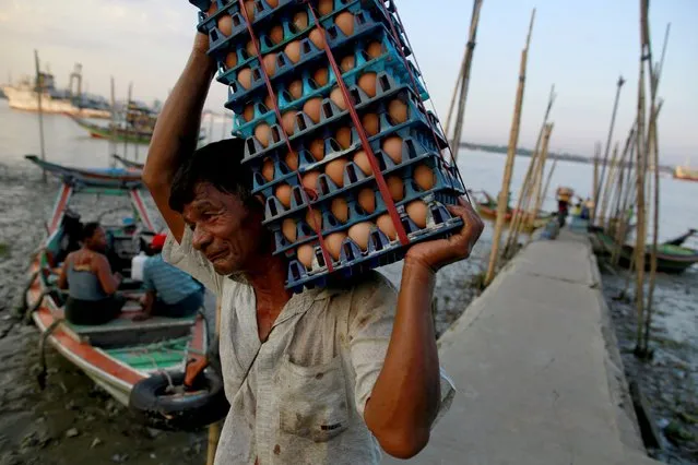 A man unload eggs from a boat in Dala, across Yangon October 23, 2015. (Photo by Soe Zeya Tun/Reuters)