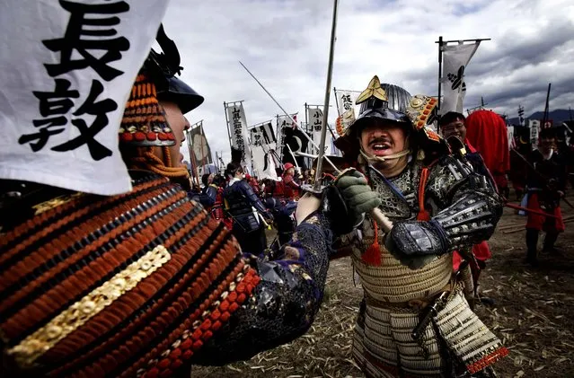 Men in samurai attire engage in sword fighting to re-enact the Battle of Kawanakajima, a battle of five campaigns fought between two forces in the age of Japan's civil war in the mid-16th century, in Fuefuki, Yamanashi Prefecture, on April 21, 2013. Kawanakajima holds a similar place in Japanese history as do Gettysburg and Waterloo in Americans and French history. (Photo by Junji Kurokawa/Associated Press)