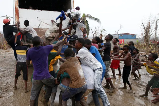 People fight while they assail a truck to try to get food after Hurricane Matthew hit Jeremie, Haiti, October 14, 2016. (Photo by Carlos Garcia Rawlins/Reuters)