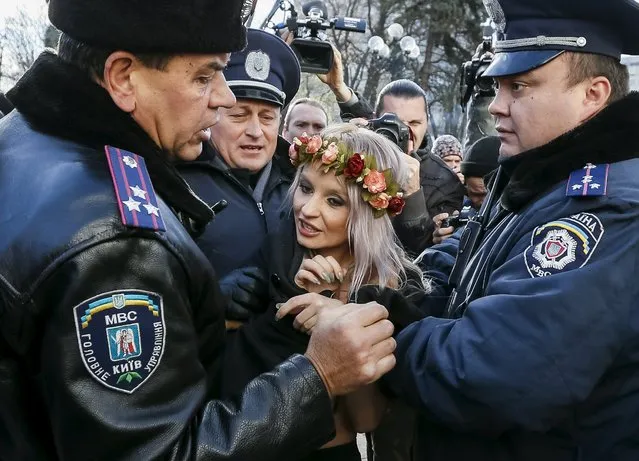 Ukrainian police detain an activist of women's rights group Femen as she protests against homophobia outside the parliament building in Kiev, Ukraine, November 12, 2015. (Photo by Gleb Garanich/Reuters)