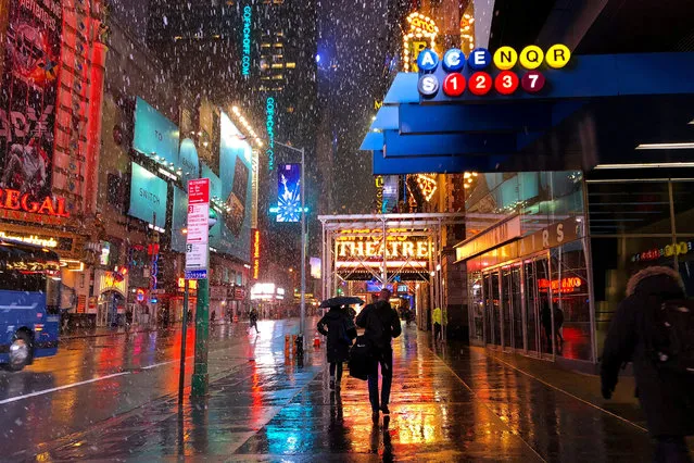 People walk to work in Midtown Manhattan during the third winter storm in two weeks early morning in New York City, NY, U.S., March 13, 2018. (Photo by Bernadette Baum/Reuters)