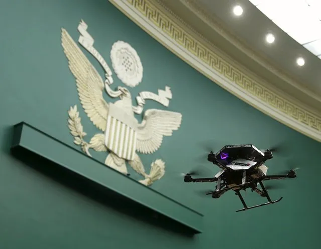 An Intel AscTec Firefly drone hovers near the Great Seal of the United States during a flight demonstration at the House Commerce, Manufacturing and Trade subcommittee on Capitol Hill in Washington November 19, 2015. (Photo by Gary Cameron/Reuters)
