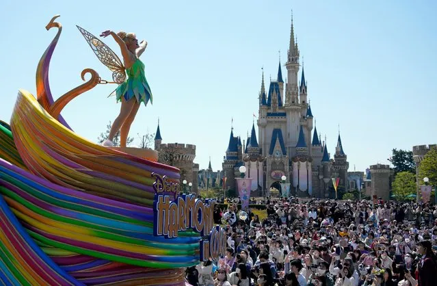 Visitors look at the 'Harmony in Color' new parade during a press preview at Tokyo Disneyland in Urayasu, Chiba Prefecture, near Tokyo, Japan, 10 April 2023. The new parade is marking the 40th anniversary of Tokyo Disneyland and will be shown daily to the public from 15 April 2023. Tokyo Disneyland opened in 1983 as the first Disney park outside of the US. (Photo by Franck Robichon/EPA/EFE/Rex Features/Shutterstock)
