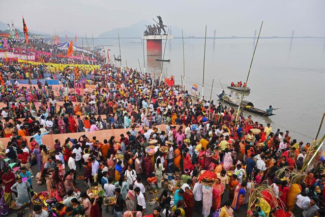 Hindu devotees offer prayers to the Sun god on the occasion of “Chhath Puja” festival, along the banks of river Brahmaputra in Guwahati on October 28, 2025. (Photo by Biju Boro/AFP Photo)