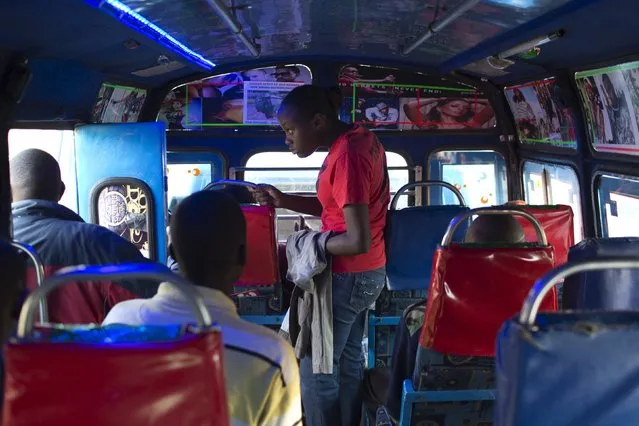 A woman looks out into the street from a bus in Baraka, Nairobi, Kenya, June 16, 2015. (Photo by Siegfried Modola/Reuters)