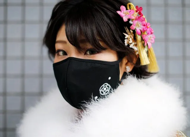 A Kimono-clad woman wearing a fashionable face mask poses for a photograph at Coming of Age Day celebration ceremony at Yokohama Arena after the government declared the second state of emergency for the capital and some prefectures, amid the coronavirus disease (COVID-19) outbreak, in Yokohama, south of Tokyo, Japan on January 11, 2021. (Photo by Issei Kato/Reuters)