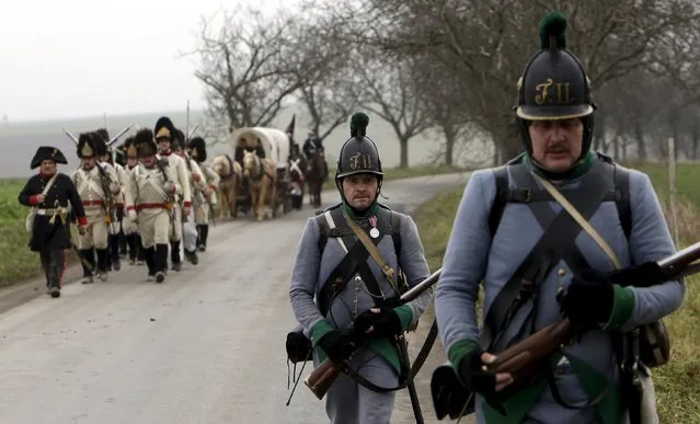 Historical re-enactment enthusiasts dressed as soldiers march near the southern Moravian village of Herspice December 4, 2015. (Photo by David W. Cerny/Reuters)