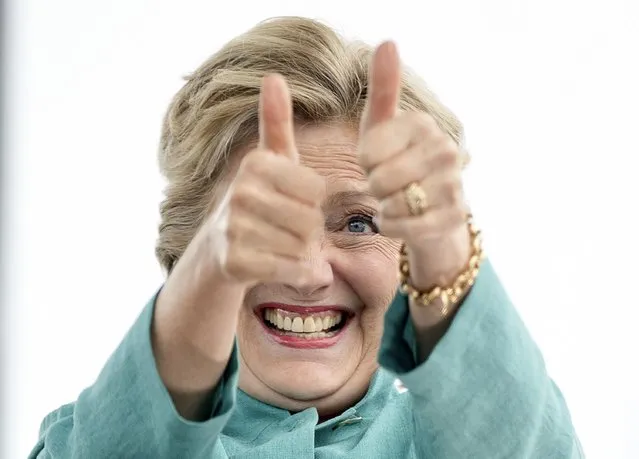 Democratic presidential candidate Hillary Clinton gives two thumbs up as she takes the stage to speak at a rally at C.B. Smith Park in Pembroke Pines, Fla., Saturday, November 5, 2016. (Photo by Andrew Harnik/AP Photo)