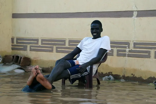 A person sits on a chair next to his flood-affected house from severe flooding in the Umm Dum area, east of Khartoum, Sudan, 08 September 2020. The Nile's flooding usually helps farmers in boosting the fertility of their lands, but this year the flooding is so severe that it has caused a dire situation in Sudan, the flood killed at least 100 people, injured dozens and left thousands homeless. Reports add that the floods threaten Sudan's ancient archeological sites. (Photo by Mohammed Abu Obaid/EPA/EFE)