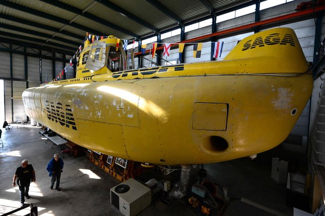 This photograph shows the submarine “Saga” imagined by former Commandant Jacques Cousteau, in a shed of l'Estaque, north surbub of Marseille, southern France, on September 20, 2024. An ordinary hangar in a working-class seaside district of Marseille is home to an exceptional vessel: the Saga, the world's largest civilian submarine, imagined by Captain Cousteau, has been brought back to life after years of neglect. (Photo by Christophe Simon/AFP Photo)
