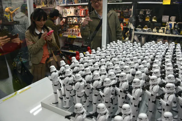 Figure models called First Order's Stormtrooper from the movie “Star Wars” are displayed in Akihabara shopping district in Tokyo, Japan, December 12, 2015. New movie “Star Wars: The Force Awakens” toys and other merchandise were released in Akihabara stores. (Photo by Hitoshi Yamada/NurPhoto via ZUMA Press)