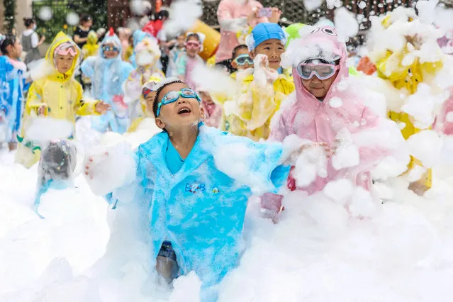 This photo taken on May 31, 2023 shows children playing with bubbles at a kindergarten during an event to celebrate International Children's Day in Nanjing, in China's eastern Jiangsu province. (Photo by AFP Photo/China Stringer Network)
