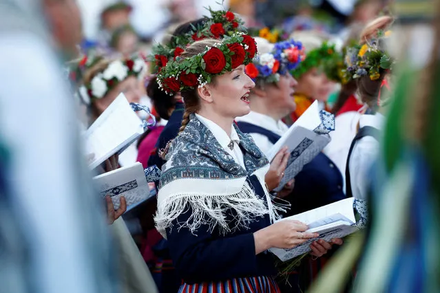 Choir performs during the final show at the Song and Dance Celebration in Riga, Latvia July 8, 2018. Song and Dance Celebration is a nationwide traditional culture event happening every five years and around 40 000 participants from 3421 amateur choirs and folk dance ensembles participating at the 2018 festival. (Photo by Ints Kalnins/Reuters)