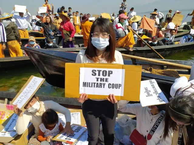 A woman holds a placard during a rally against the military coup in Inle Lake, Myanmar, February 11, 2021.. (Photo by Reuters/Stringer)