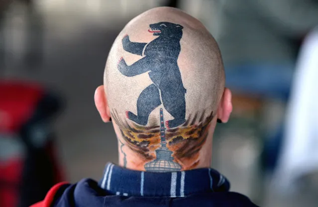 A man with a tattoo on his head showing the “Berlin Bear” and the dome of the television tower in Berlin, Germany, 28 Germany 2015. (Photo by Britta Pedersen/EPA)