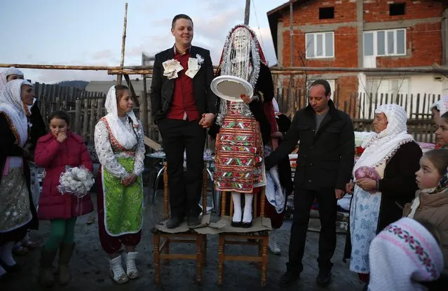 Bulgarian Muslims Azim Liumankov (C left) and his bride Fikrie Bindzheva pose in front of their house during their wedding ceremony in the village of Ribnovo, in the Rhodope Mountains, February 15, 2015. (Photo by Stoyan Nenov/Reuters)