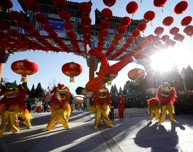 Traditional dancers perform lion dance during the opening of the temple fair for the Chinese New Year celebrations at Ditan Park, also known as the Temple of Earth, in Beijing February 18, 2015. (Photo by Kim Kyung-Hoon/Reuters)