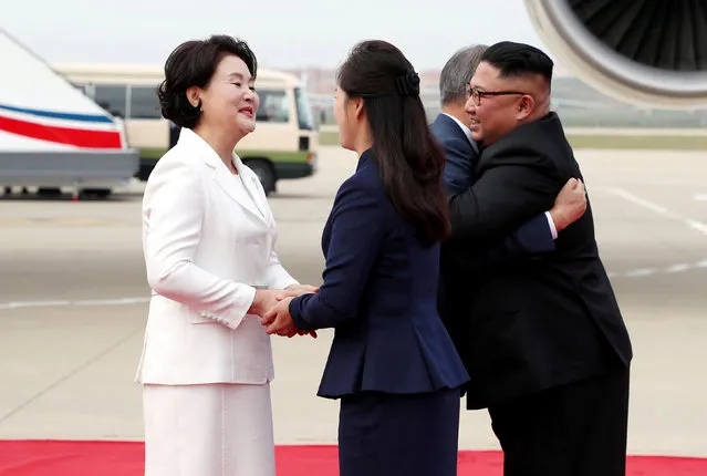 South Korean President Moon Jae-in is greeted by North Korean leader Kim Jong Un during an official welcome ceremony at Pyongyang Sunan International Airport, in Pyongyang, North Korea, September 18, 2018. (Photo by Pyeongyang Press Corps/Pool via Reuters)