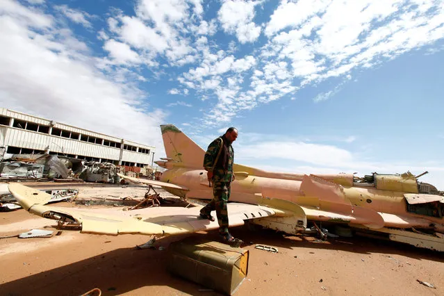 A military aircraft of deposed Libyan leader Muammar Gaddafi's lies destroyed at the airport in Sirte, October 6, 2011. Rebels said that the aircraft was destroyed by NATO air strikes. (Photo by Anis Mili/Reuters)