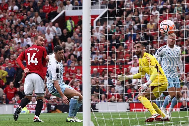 Manchester United's Danish midfielder #14 Christian Eriksen scores a goal during the English Premier League football match between Manchester United and Nottingham Forest at Old Trafford in Manchester, northwest England, on August 26, 2023. (Photo by Darren Staples/AFP Photo)