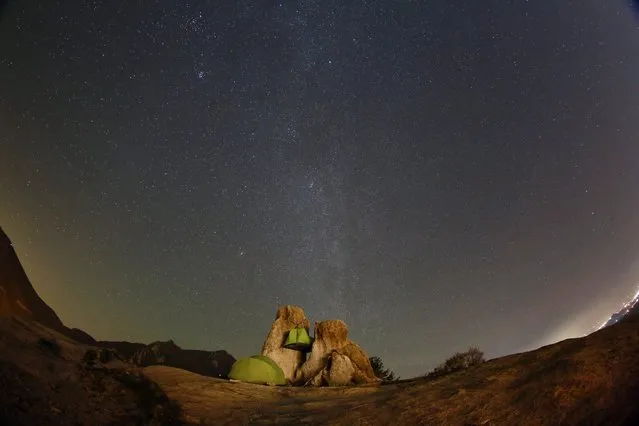 Stars light up the sky above campers, over the rock of Seoraksan Mountain, 250 kilometers northeast of Seoul, South Korea, 30 October 2016. (Photo by Jeon Heon-Kyun/EPA)