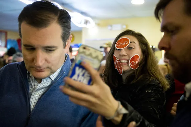 Delaney Anne tries to make a selfie with Republican presidential candidate, Sen. Ted Cruz, R-Texas, during a campaign stop, Monday, January 18, 2016, in Tilton, N.H. (Photo by Matt Rourke/AP Photo)