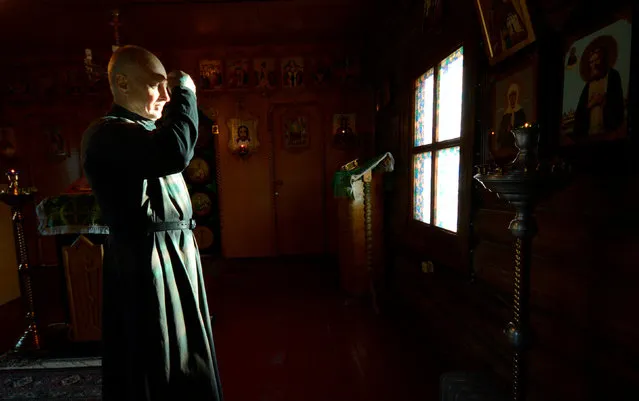 A lector prays at the church of St. Daniel of Moscow in the village of Malokurilskoye on the island of Shikotan, Southern Kuriles, Russia, December 18, 2016. (Photo by Yuri Maltsev/Reuters)