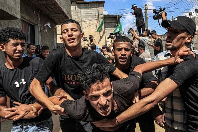 Mourners react during the funeral of 25-year-old Palestinian Yousef Radwan, who was killed the previous day amid clashes following anti-Israel protests by the Gaza Strip's eastern border fence, in Khan Yunis in the southern Gaza Strip on September 20, 2023.  (Photo by Said Khatib/AFP Photo)