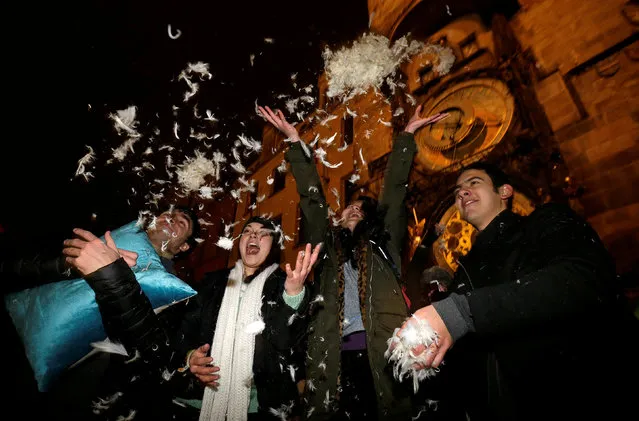 People take part in a four-minute flash mob pillow fight at the Old Town Square in Prague, Czech Republic, December 22, 2016. (Photo by David W. Cerny/Reuters)