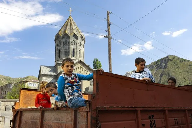 Ethnic Armenian children from Nagorno-Karabakh look from a truck after arriving in Armenia's Goris in Syunik region, Armenia, on Thursday, September 28, 2023. The separatist government of Nagorno-Karabakh announced Thursday that it will dissolve itself and the unrecognized republic will cease to exist by the end of the year, and Armenian officials said more than half of the population has already fled. More than half of the region's population has already fled to Armenia, according to Armenian officials. (Photo by Vasily Krestyaninov/AP Photo)