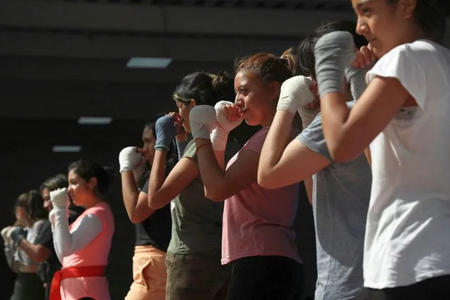 Women participate in a self-defense class that combines martial arts with simple street fighting techniques, in the Iztapalapa neighborhood on the outskirts of Mexico City, Mexico on March 7, 2023. (Photo by Raquel Cunha/Reuters)