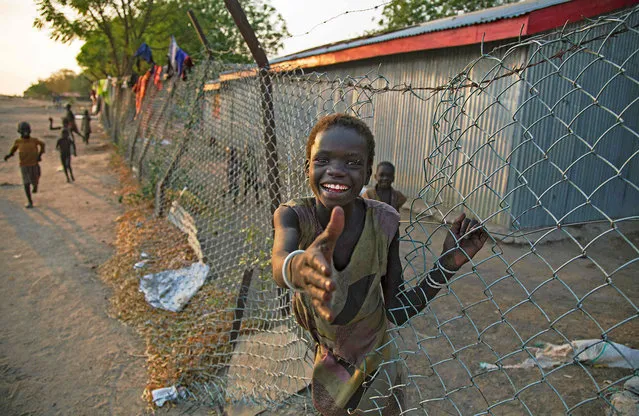 A child climbs through a fench inside the former compound of the International Committee of the Red Cross (ICRC) in the half-emptied village of Leer, South Sudan, on February 3, 2016. A large part of the civilian population fled the village due to the fighting between Army forces and the Sudan People's Liberation Movement in Opposition (SPLM-IO) on October 2, 2015. (Photo by Albert Gonzalez Farran/AFP Photo)