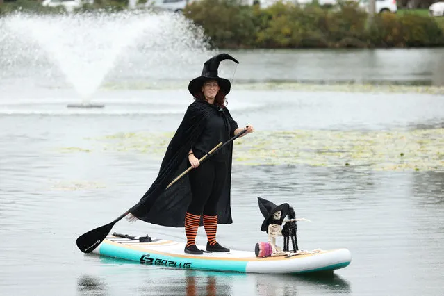 Dozens of people wearing witch costumes stand-up on paddle boards to take part in a Halloween float, in Spring Lake, New Jersey, United States on October 14, 2023. (Photo by Lokman Vural Elibol/Anadolu via Getty Images)