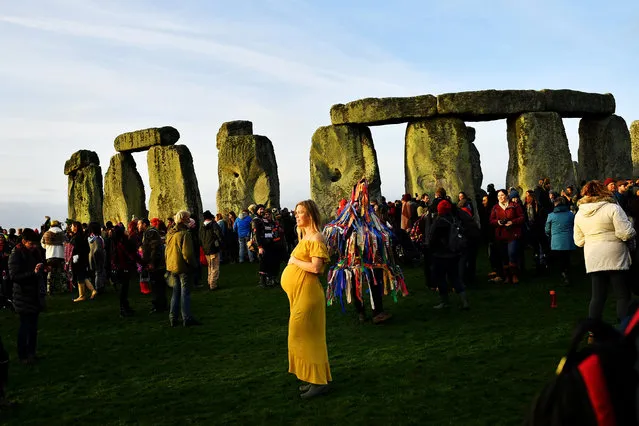 Ann Bloom, from Canada, joins revellers as they welcome in the winter solstice at Stonehenge stone circle, in Amesbury, Britain, December 22, 2018. (Photo by Dylan Martinez/Reuters)