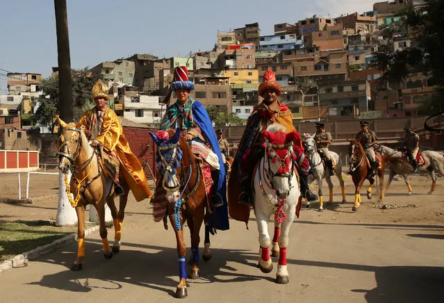 Peruvian policemen dressed as the Three Kings greet spectators as they ride horses during Epiphany celebrations, or Three Kings' Day, in central Lima, Peru, January 6, 2017. (Photo by Mariana Bazo/Reuters)