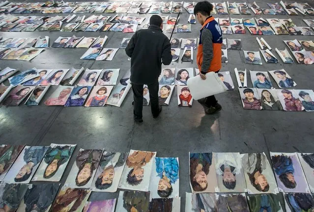 Teachers select and grade paintings done by candidates taking part in an entrance examination at China Academy of Art in Hangzhou, Zhejiang province, March 25, 2015. (Photo by Chance Chan/Reuters)