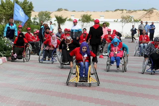 Disabled Palestinians participate in a race during an event organized by United Nations at a U.N-run training center in Khan Younis in the southern Gaza Strip April 8, 2015. The event was aimed at raising awareness on the impact of Explosive Remnants of War (ERW), officials said. (Photo by Ibraheem Abu Mustafa /Reuters)
