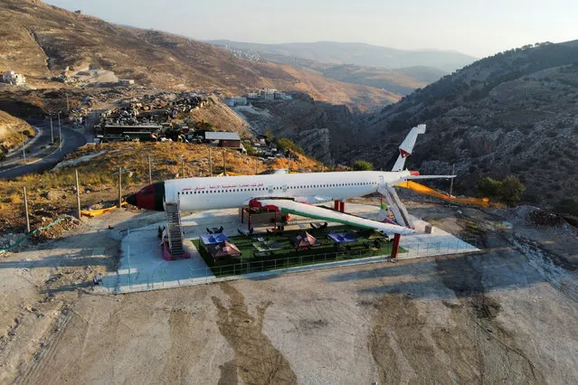 Palestinians prepare a restaurant in a converted airplane that was bought from scrap metal in Israel, in Nablus in the Israeli-occupied West Bank on August 10, 2021. (Photo by Mohamad Torokman/Reuters)
