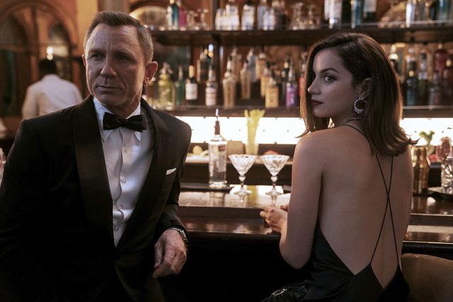 This image released by Metro Goldwyn Mayer Pictures shows Daniel Craig, left, Ana de Armas in a scene from “No Time To Die”. (Photo by Nicola Dove/Metro Goldwyn Mayer Pictures via AP Photo)