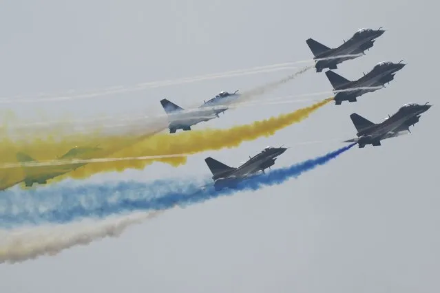 Members of the “August 1st” Aerobatic Team of the Chinese People's Liberation Army (PLA) Air Force perform during the 13th China International Aviation and Aerospace Exhibition on Wednesday, September 29, 2021, in Zhuhai in southern China's Guangdong province. (Photo by Ng Han Guan/AP Photo)