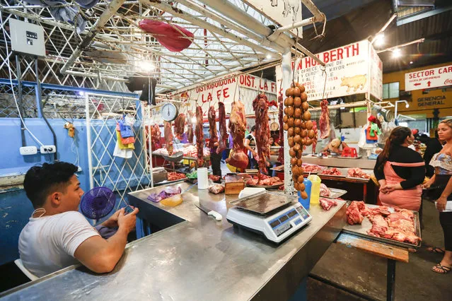 In this December 21, 2018 photo, a vendor waits for customers at a market in Managua, Nicaragua. In the streets of Managua, outward appearances suggest some degree of normality. But vendors say business has been running 25 to 30 percent below what it was last year, even in the run-up to Christmas. (Photo by Alfredo Zuniga/AP Photo)