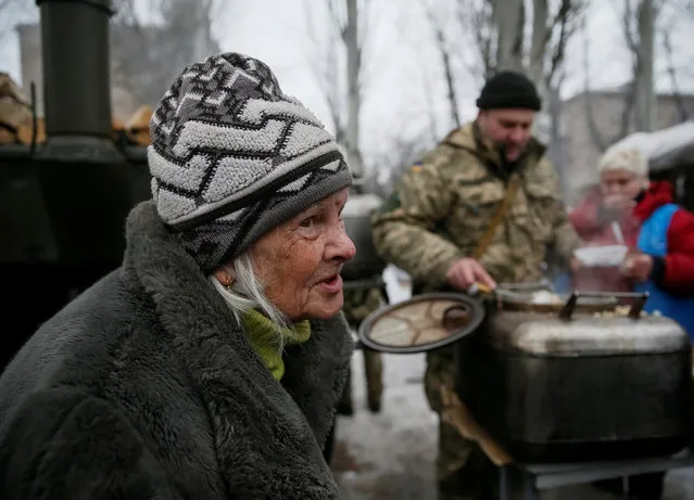 A local resident waits for a meal at an emergency center after shelling hit supply infrastructure in the government-held industrial town of Avdiyivka, Ukraine, February 3, 2017. (Photo by Gleb Garanich/Reuters)