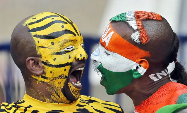 India, right, and Bangladesh cricket fans with faces painted in the colors of their national flags shout to cheer for their teams during the third day of the cricket test match between India and Bangladesh in Hyderabad, India, Saturday, February 11, 2017. (Photo by Aijaz Rahi/AP Photo)