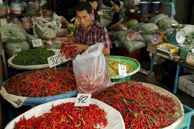 A vendor sells chili peppers at his stall at a market in Bangkok, Thailand March 31, 2016. (Photo by Jorge Silva/Reuters)