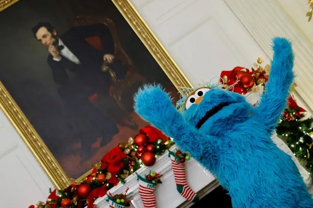 Rosita, a character from the children's television series Sesame Street, gestures in front of Abraham Lincoln's portrait, during an event with children hosted by U.S. first lady Jill Biden of as part of the Christmas decoration and holiday reception kickoff at the White House, in Washington, U.S., November 29, 2021. (Photo by Jonathan Ernst /Reuters)