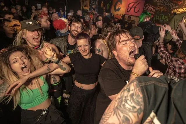 The lead singer of Corrupt Vision jumps into the crowd to perform one of their songs at Manchester Punk festival in Manchester, northern England in the last decade of March 2024. (Photo by Chris Bethell/The Guardian)