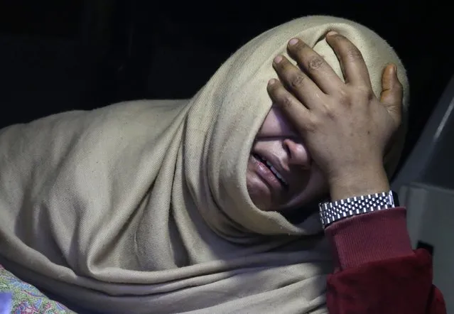 A woman cries inside an ambulance after she lost her family member during a heavy snowfall-hit area in Murree, some 28 miles (45 kilometers) north of the capital of Islamabad, Pakistan, Saturday, January 8, 2022. Temperatures fell to minus 8 degrees Celsius (17.6 Fahrenheit) amid heavy snowfall at Pakistan's mountain resort town of Murree overnight, killing multiple people who were stuck in their vehicles, officials said Saturday. (Photo by Rahmat Gul/AP Photo)