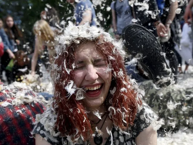 A woman reacts as she takes part in a pillow fight during a flash mob in Kiev, Ukraine, April 24, 2016. (Photo by Valentyn Ogirenko/Reuters)
